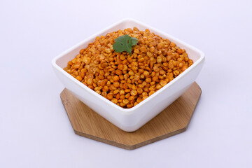Fried and Spicy Chana Masala Dal, white bowl on dark background, Chana Dal is a very popular Gujarati snack