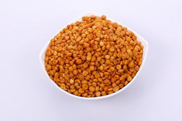 
Fried Salted Chana Dal Masala in white bowl on dark background. Chana Dal is a very popular Gujarati snack.