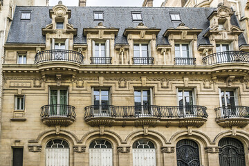 Old French house with traditional balconies and windows. Paris, France.