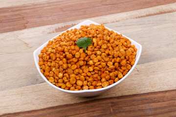 Fried and Spicy Chana Masala Dal, Chana Dal is a very popular Gujarati snack, white bowl on wooden background