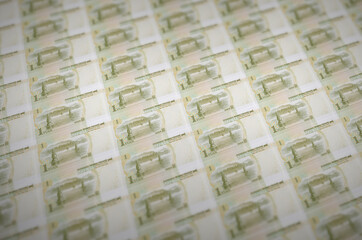 1 Chinese yuan bills printed in illegal money production conveyor. Collage of many fake bills....