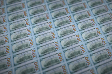 100 US dollars bills printed in illegal money production conveyor. Collage of many fake bills....