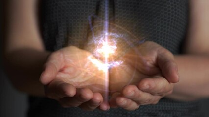 Woman creates and holds a clot of vital energy in her palms. Glowing lights in woman hands. Concept of sharing, giving, offering, taking care, protection. UHD, 4K