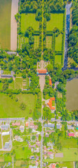 Aerial panorama of Beautiful avenue of trees in the grounds of Nieborow Palace, a Baroque style residence in Poland. Colourful French-design garden