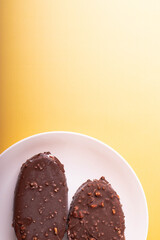 tasty cold chocolate ice cream with nuts pieces on wooden stick