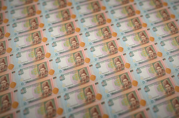 100 Ukrainian hryvnias bills printed in illegal money production conveyor. Collage of many fake...