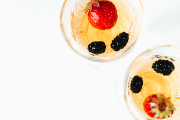 Vintage Wineglass with wine and berries top view isolate on white background.
Summer cool drinks. space for text. 