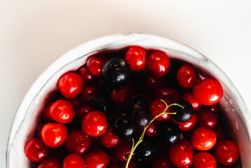 Cherries in marble plate Isolate on white background. Autumn harvest of berries view point.  Place for text