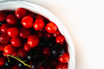 Cherries in marble plate Isolate on white background. Autumn harvest of berries.  Place for text
