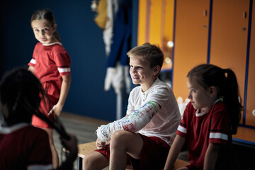 Team care on sport boy after physical accident.
