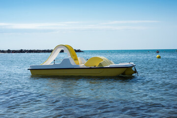 Closeup of plastic pedalo in the sea on blus sky background