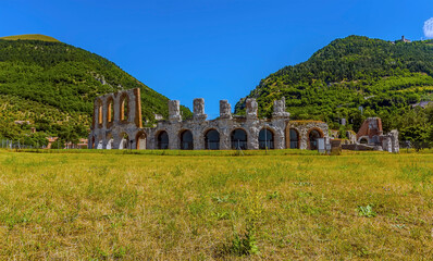 Fototapeta na wymiar The ruins of the Roman ampitheater at the foot of Mount Ingino in the cathedral city of Gubbio, Italy in summer