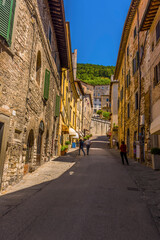 A view up a hillside street in the cathedral city of Gubbio, Italy in summer
