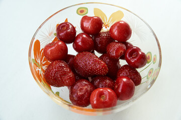 Fresh strawberries and cherries organic in a bowl
