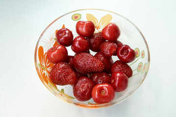 Fresh strawberries and cherries organic in a bowl