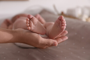 Mother and her little baby on bed, closeup