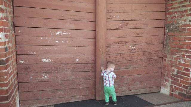 A boy near the wooden gate