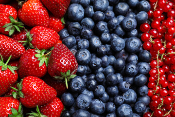 Mix of different ripe tasty berries as background, top view