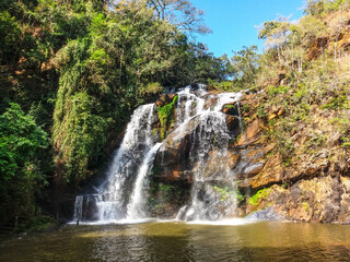 Fototapeta na wymiar Beaultiful waterfall around the rocks. Located at Rio Acima city in Brazil.