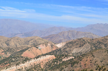 Mountains of Uzbekistan, a very beautiful landscape against a blue sky with clouds. View of the mountains. Beldersay.