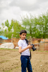 young photographer and boy in white shirt
