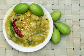 Closeup of Spondias Mombin or Hog Plum Chutney or Sauce in a Plate with Raw Fruits