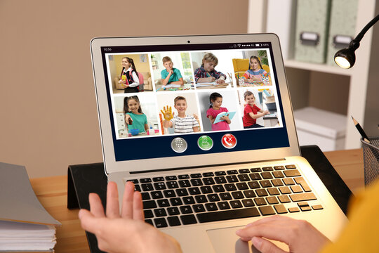 Teacher Giving Online School Lesson During Quarantine And Social Distancing Due To Covid-19 Pandemic, Closeup. Pupils Studying At Home Via Video Conference