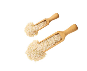 organic sesame seeds spill out of a wooden scoop isolated on a white background. Top view.