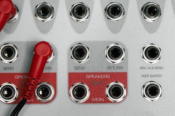 Rear panel of music system amplifier with wires
