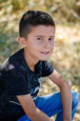 handsome boy model in black shirt, natural background
