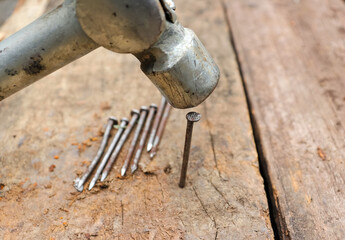 Hitting or Pounding a Nail on Wood with Hammer