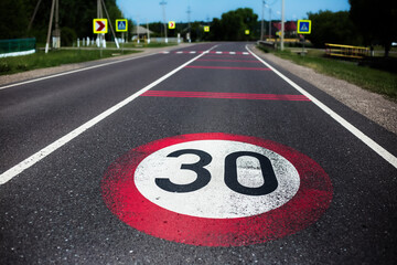 30km/h speed limit sign painted on asphalting road. - obrazy, fototapety, plakaty