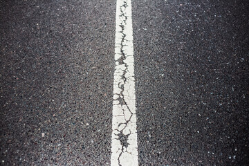 White dividing line on asphalting road.
