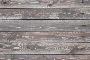 Fototapeta premium Old wooden boards, wood wall texture. Brown knotted unpainted panels for background
