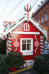 Journey to Christmas Festival 2020 in Moscow city, Russia. New Year's, Christmas decor on street. Christmas market, fair on Manezhnaya Square near Red Square. Red house with candies, sweets. Fir-tree