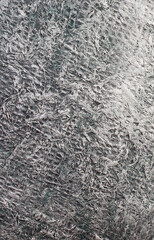 Crumpled dark background under metal. Wrinkled texture.