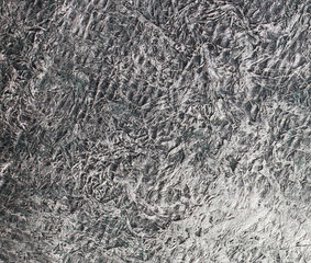 Crumpled dark background under metal. Wrinkled texture.