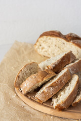 Loaf of homemade bread with sliced bread from wheat and seeds on parchment paper