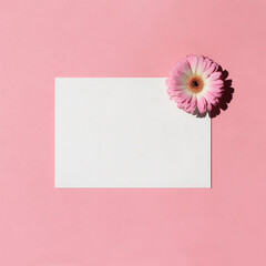 Blank white a5 paper mockup with gerbera flower isolated on a pink background. Flat lay, top view. Branding identity. Add your text.