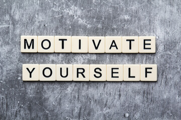 Motivational phrase Motivate yourself formed with plastic letters
