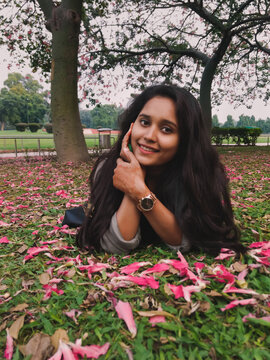 Portrait of beautiful Indian girl smiling with perfect smile and white teeth in a park and looking at camera.