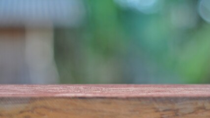 Wooden board on green bokeh background. Can be used for display or montage your products.