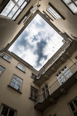 Narrow Courtyard With View Up To The Cloudy Sky Of A Historic Building