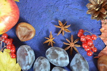 Autumn harvest, grapes, autumn fallen leaves, apples, plums, cinnamon, anise. wild grapes in autumn in the rain.