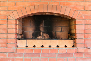 Fireplace from red bricks. Close up view