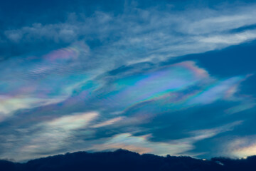 The beauty of the rainbow clouds Above the black clouds in the evening.