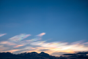 The beauty of the rainbow clouds Above the black clouds in the evening.