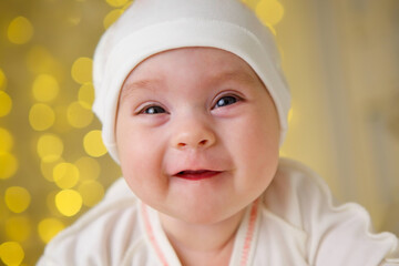 Little newborn baby girl lying in white clothes