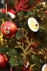 Christmas tree. New Year decorations: balls for fir-tree. Elements of New Year decor to create Christmas mood in interior. Magical lights and flickering of colorful balls, toys in holiday. Xmas party