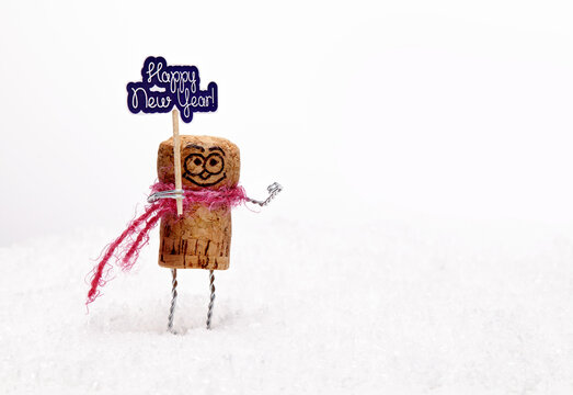Funny wine cork man on white snow wishes anybody "happy new year". - Powered by Adobe